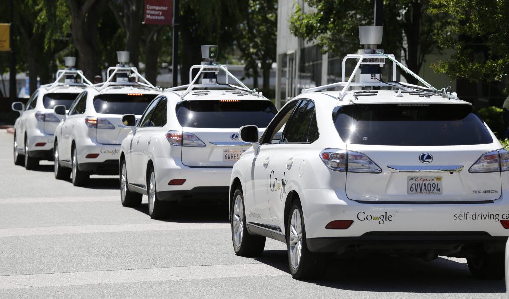 In this photo taken Wednesday, May 14, 2014, a row of Google self-driving cars are shown outside the Computer History Museum in Mountain View, Calif. Four years ago, the Google team developing cars which can drive themselves became convinced that, sooner than later, the technology would be ready for the masses. There was just one problem: Driverless cars almost certainly were illegal.(AP Photo/Eric Risberg)