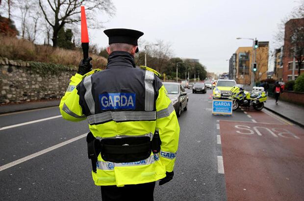 Garda Stopping Vehicles at a Checkpoint
